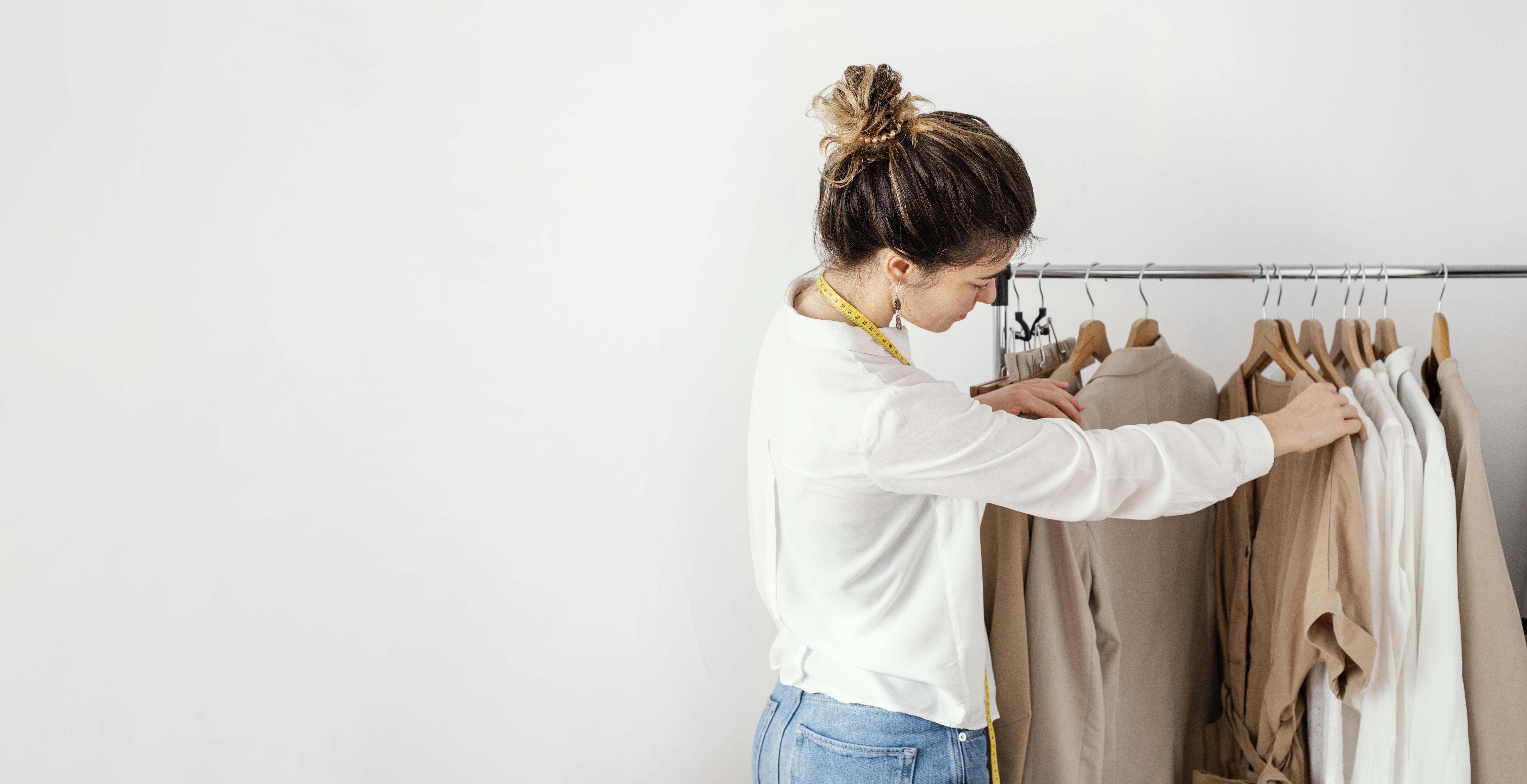 woman going trough a rack full of clothes